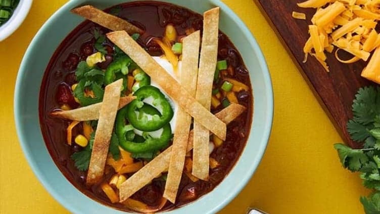 Spicy Vegetarian Tortilla Soup shown made with the recipe ingredients and served in a bowl, ready to be enjoyed.