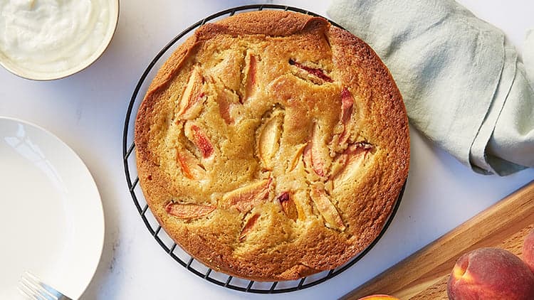 Peach Olive Oil Cake shown fresh out of the oven and ready to served and enjoyed.