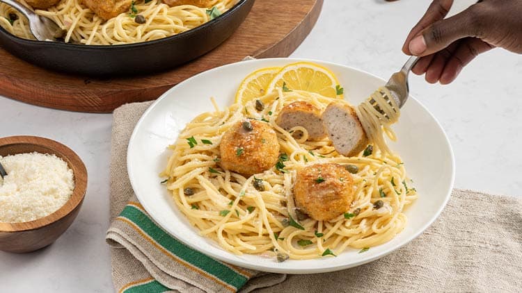 Bell & Evans Lemon Chicken Piccata Meatballs shown served in a bowl, ready to be enjoyed.